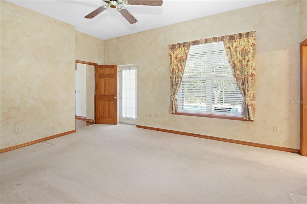 400 Interlachen Court DeBary, FL 32713 - Photo 27 of 42 an empty room with a window and a ceiling fan