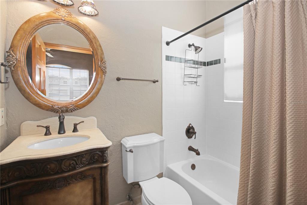 400 Interlachen Court DeBary, FL 32713 - Photo 35 of 42 a bathroom with a sink a toilet and a mirror