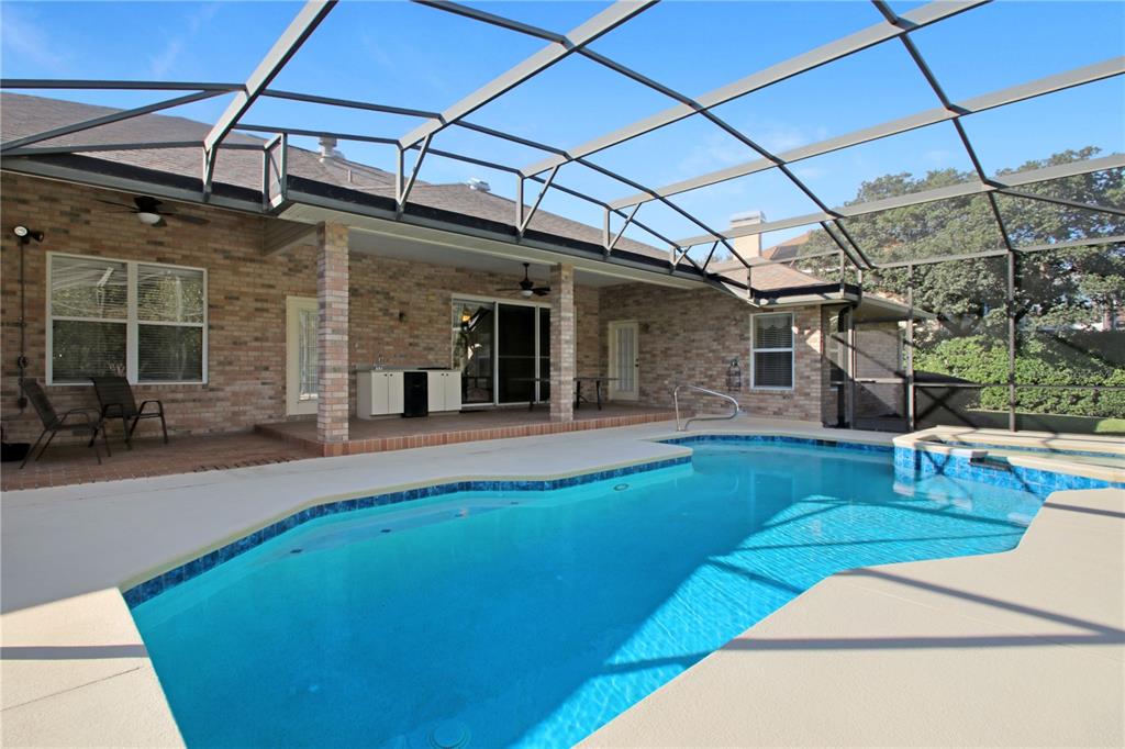 400 Interlachen Court DeBary, FL 32713 - Photo 40 of 42 a view of a backyard with a patio and a garden
