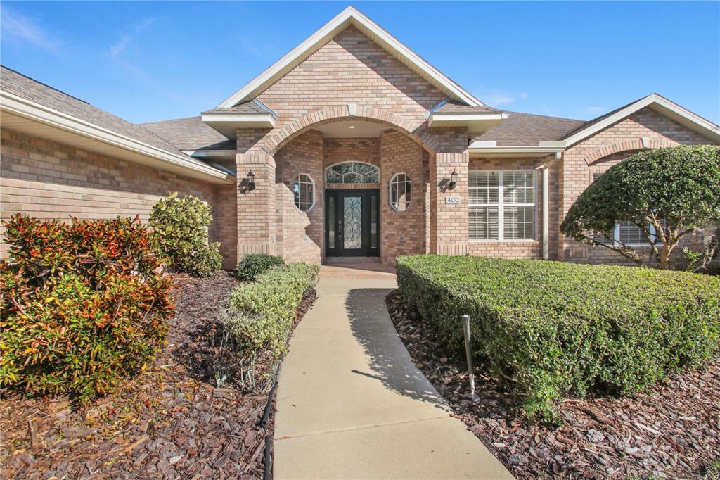 400 Interlachen Court DeBary, FL 32713 - Photo 4 of 42 a view of a brick house with a large windows