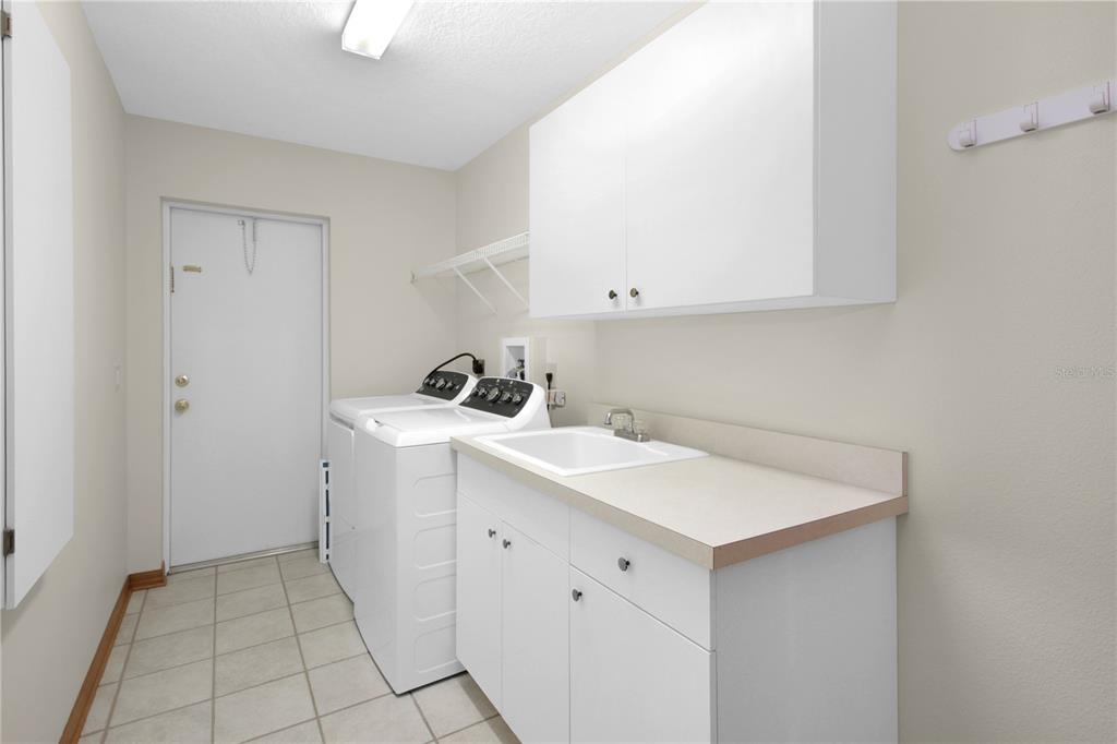 400 Interlachen Court DeBary, FL 32713 - Photo 10 of 42 a utility room with cabinets washer and dryer