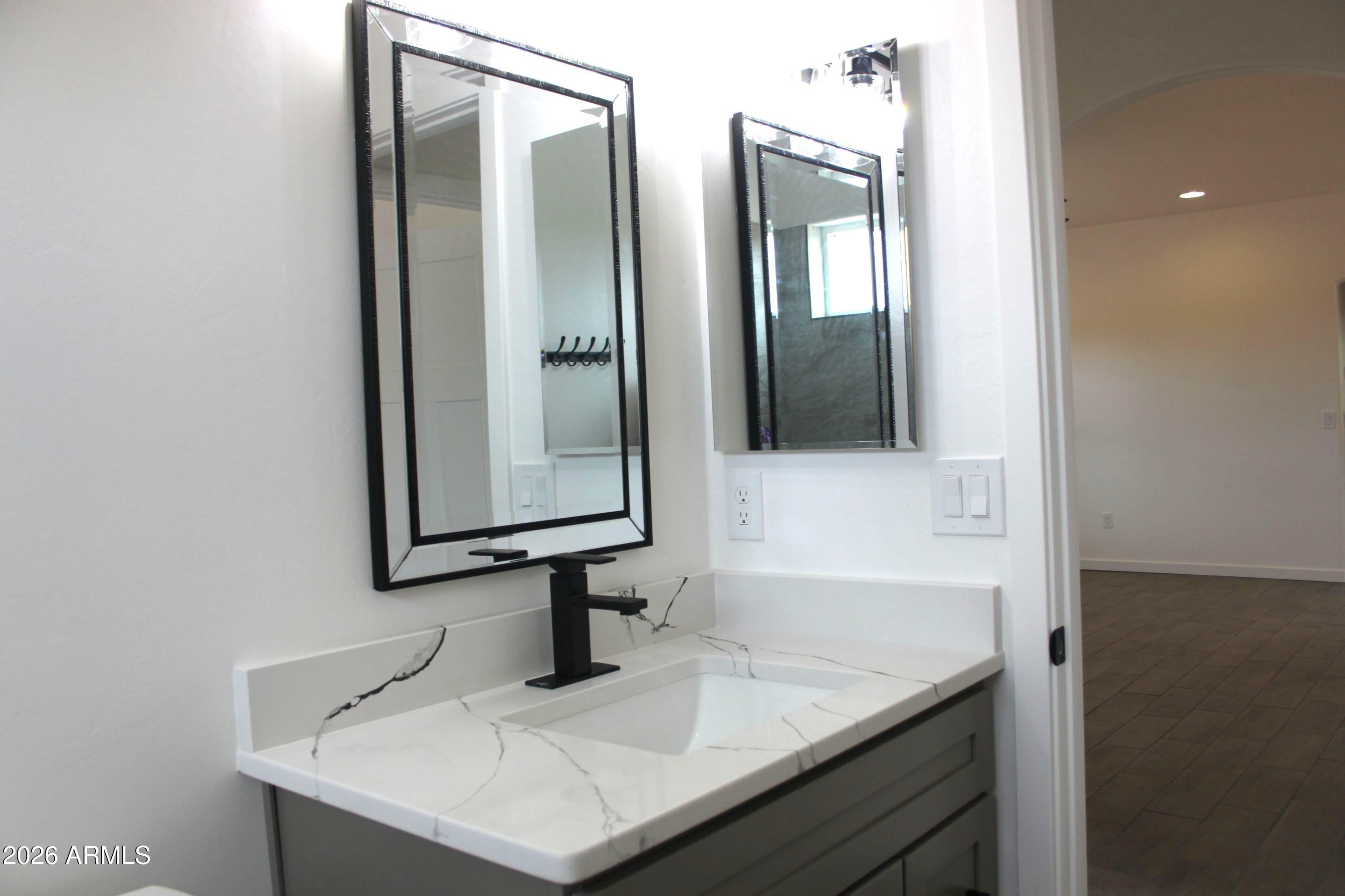 6370 South Jaxel Road Hereford, AZ 85615 - Photo 25 of 58 a bathroom with double sink and mirror