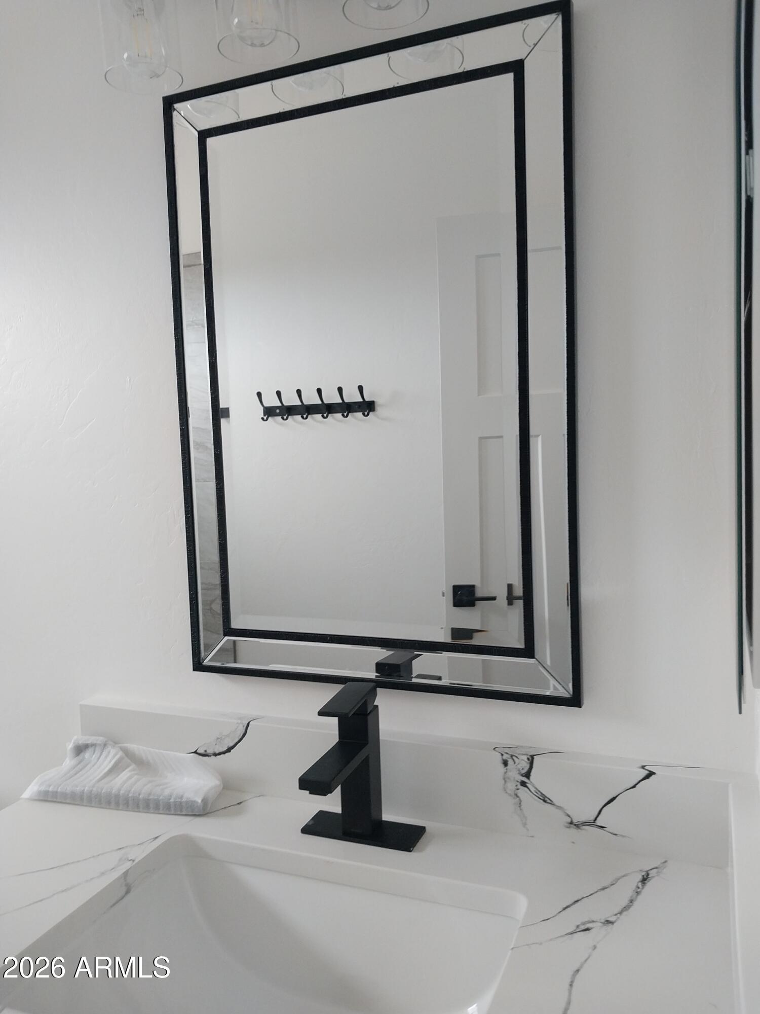 6370 South Jaxel Road Hereford, AZ 85615 - Photo 26 of 58 a bathroom with a sink and a mirror