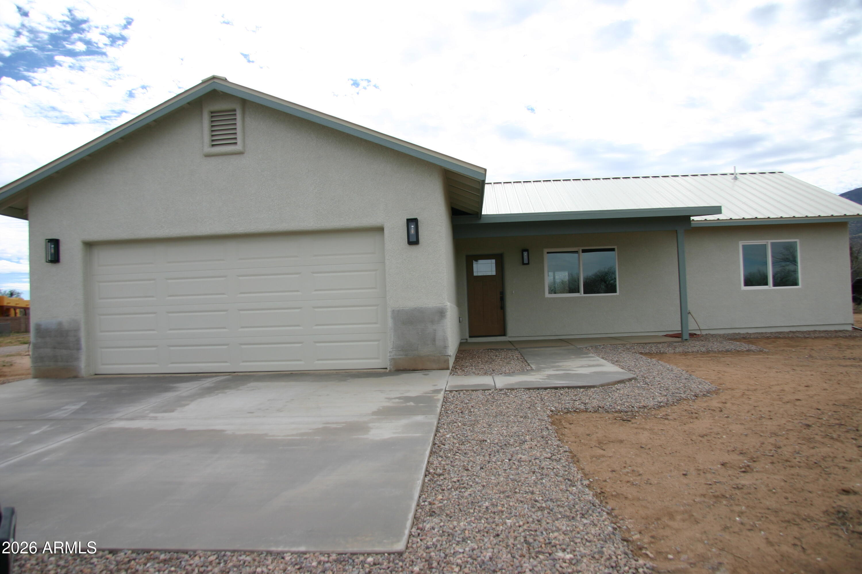 6370 South Jaxel Road Hereford, AZ 85615 - Photo 3 of 58 a front view of a house with garage