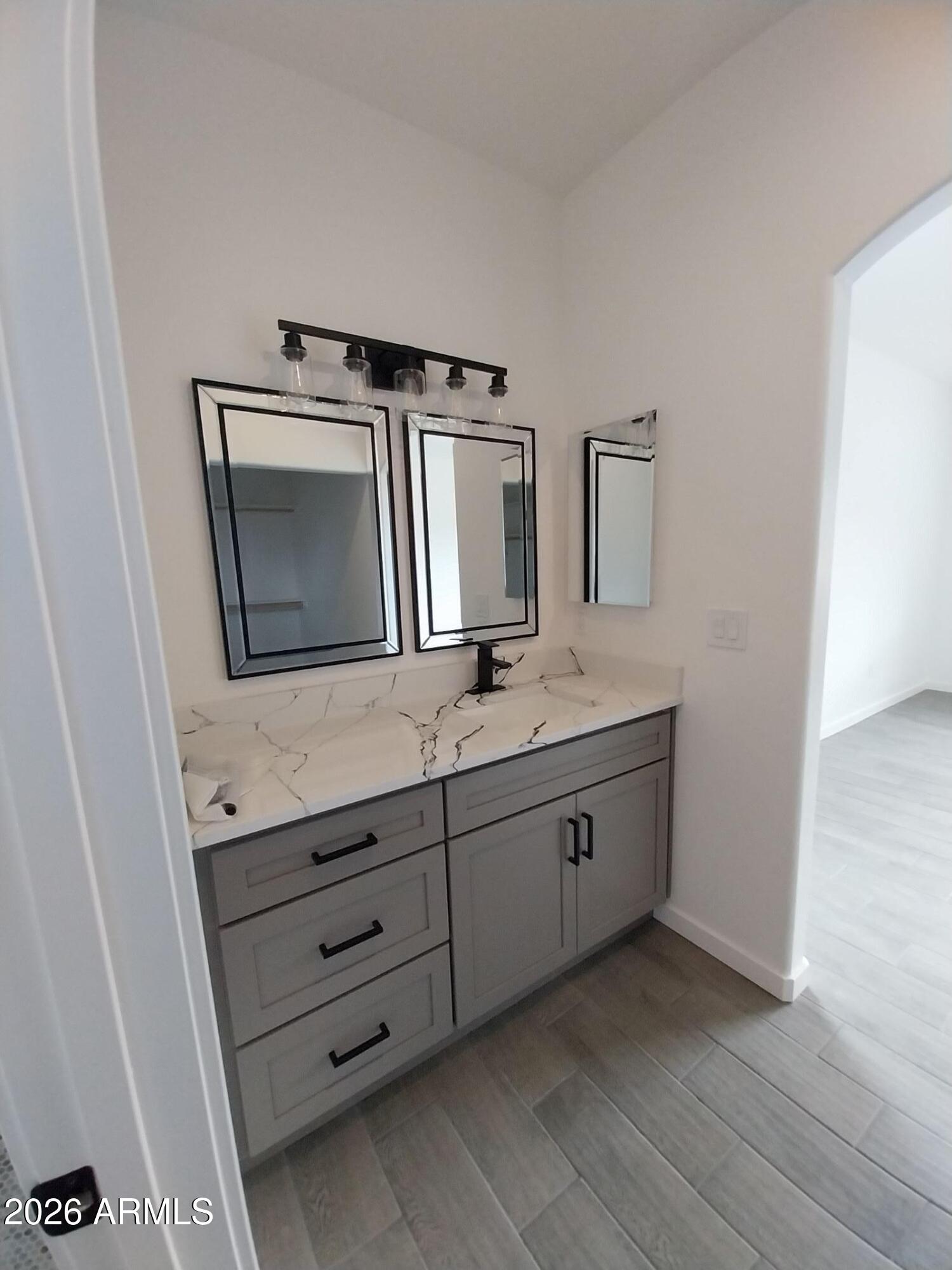 6370 South Jaxel Road Hereford, AZ 85615 - Photo 33 of 58 a bathroom with a granite countertop toilet sink and mirror