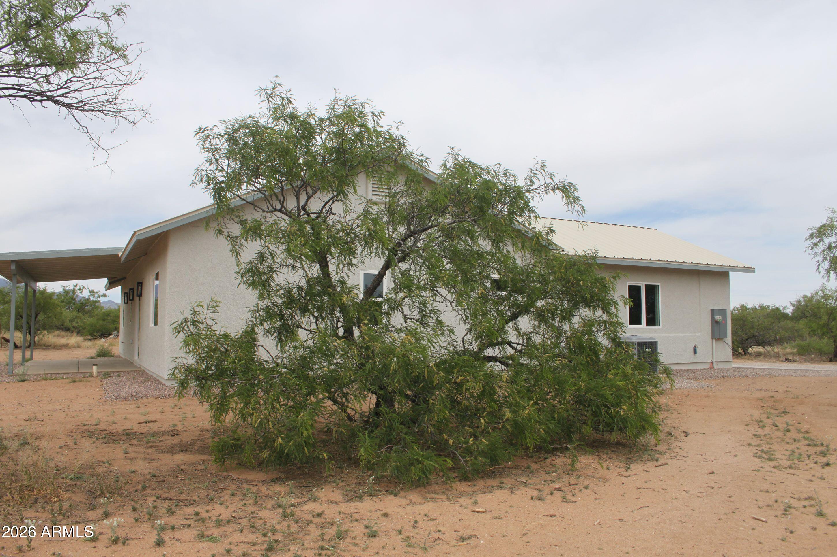 6370 South Jaxel Road Hereford, AZ 85615 - Photo 53 of 58 a backyard of a house with plants and trees