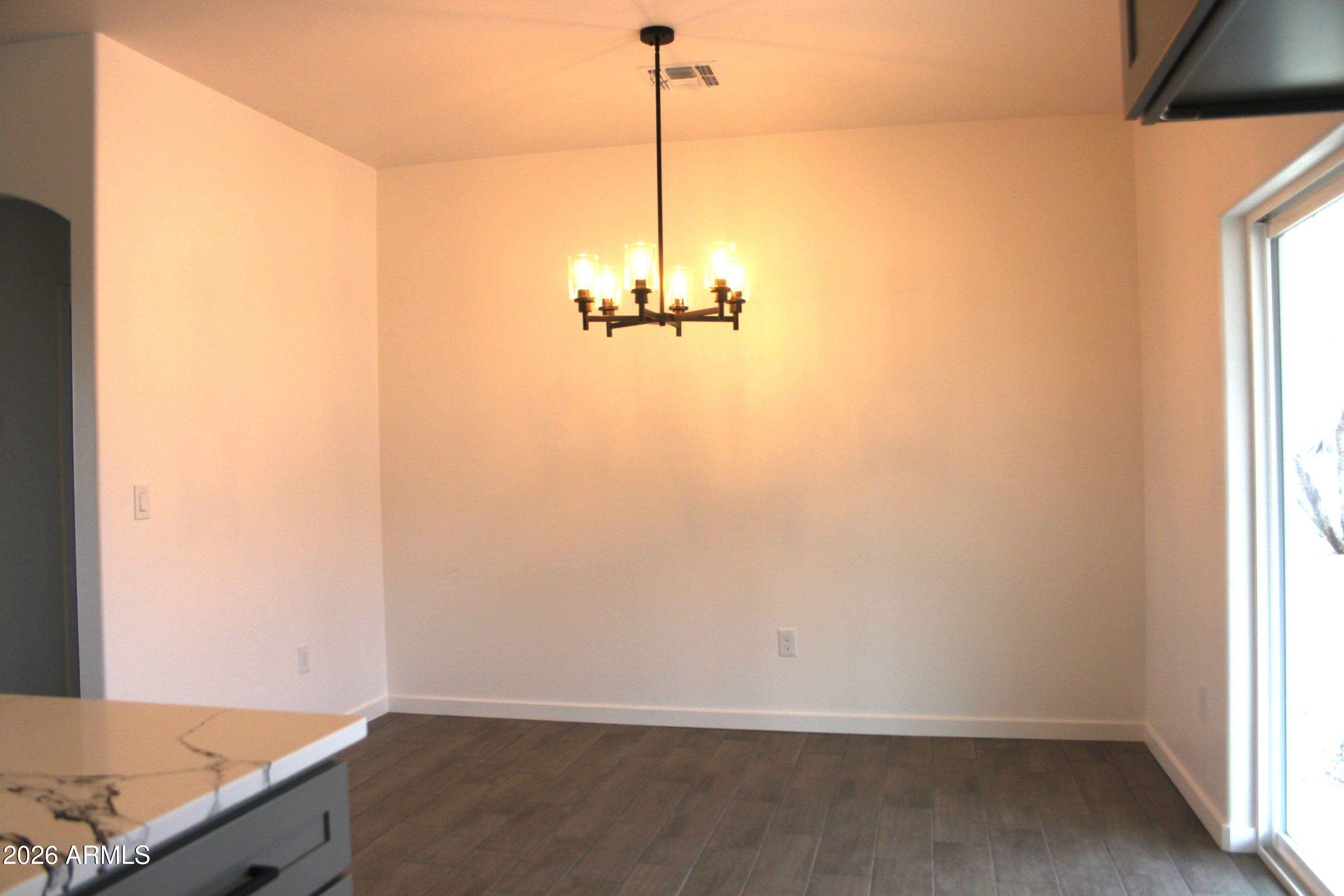 6370 South Jaxel Road Hereford, AZ 85615 - Photo 10 of 58 a view of a room with a window and wooden floor