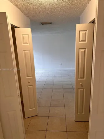 an empty room with a empty space and a window