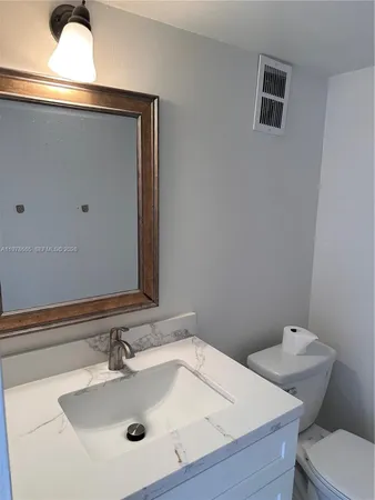 a kitchen with a sink and a refrigerator