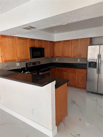 a kitchen that has a sink and a stove