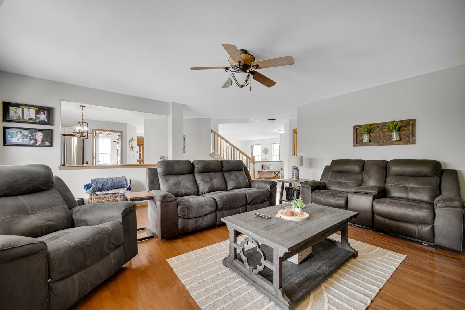 25421 Faraday Road Manhattan, IL 60442 - Photo 13 of 36 a living room with furniture a rug and a chandelier