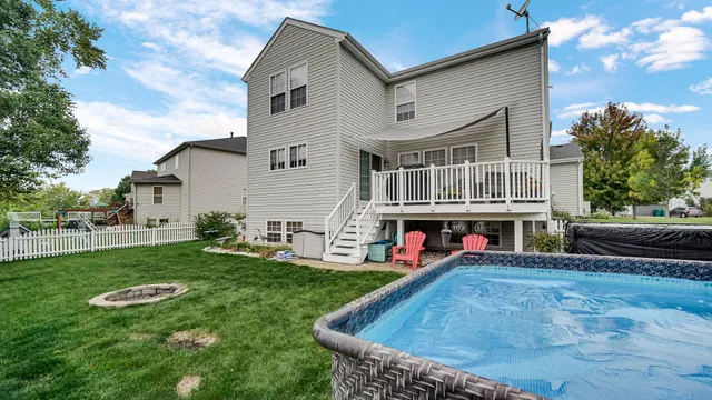a view of a house with backyard and sitting area