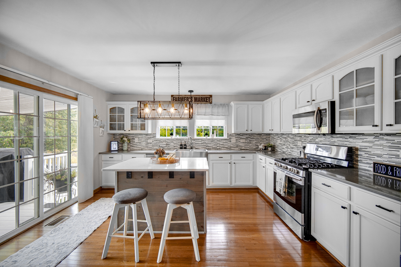 25421 Faraday Road Manhattan, IL 60442 - Photo 7 of 36 a kitchen with a sink stove cabinets and wooden floor