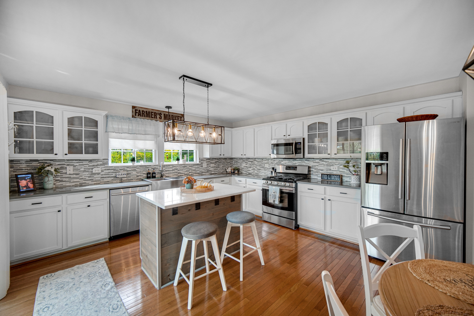 25421 Faraday Road Manhattan, IL 60442 - Photo 10 of 36 a kitchen with granite countertop stainless steel appliances a sink stove refrigerator and cabinets
