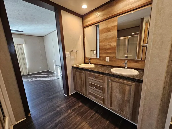 a bathroom with a sink a mirror and a shower