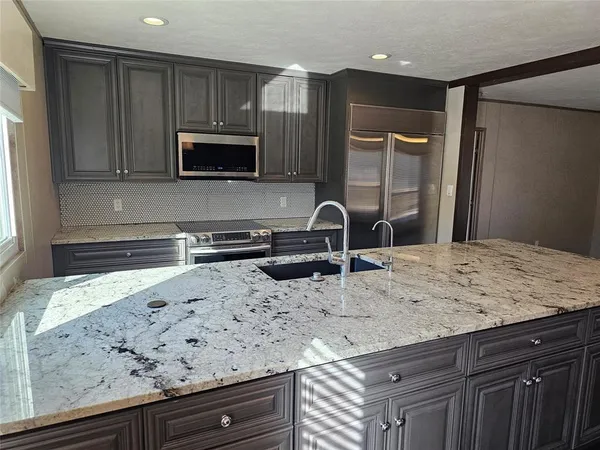 a kitchen with sink cabinets and microwave