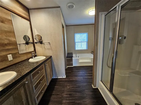 a bathroom with a sink a mirror and a shower