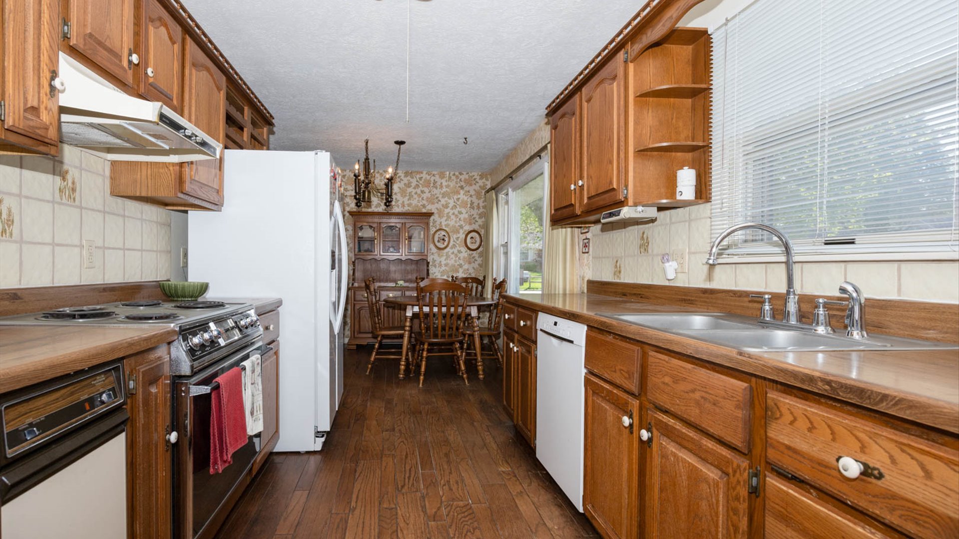 1209 Spear Drive Normal, IL 61761 - Photo 11 of 31 a kitchen with wooden cabinets and sink