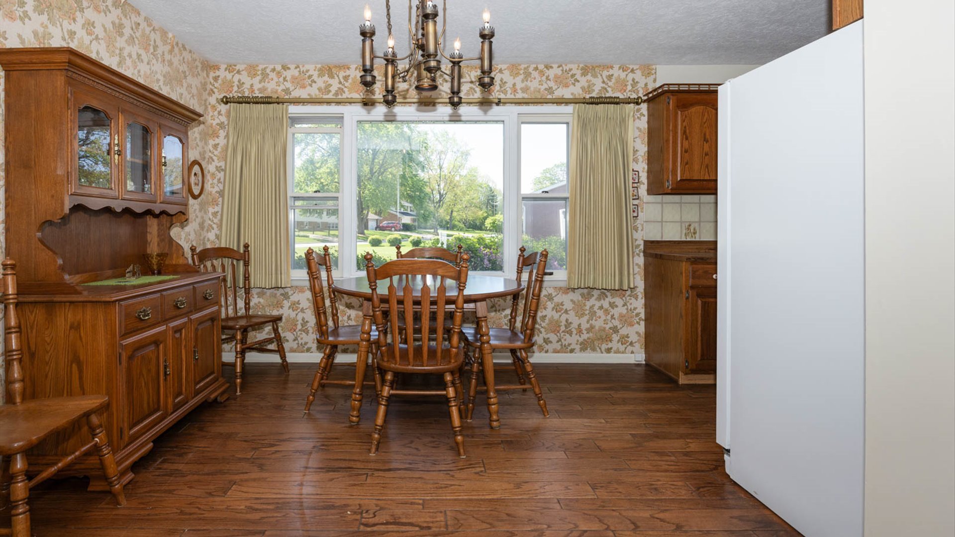 1209 Spear Drive Normal, IL 61761 - Photo 12 of 31 a dining room with furniture a chandelier and wooden floor