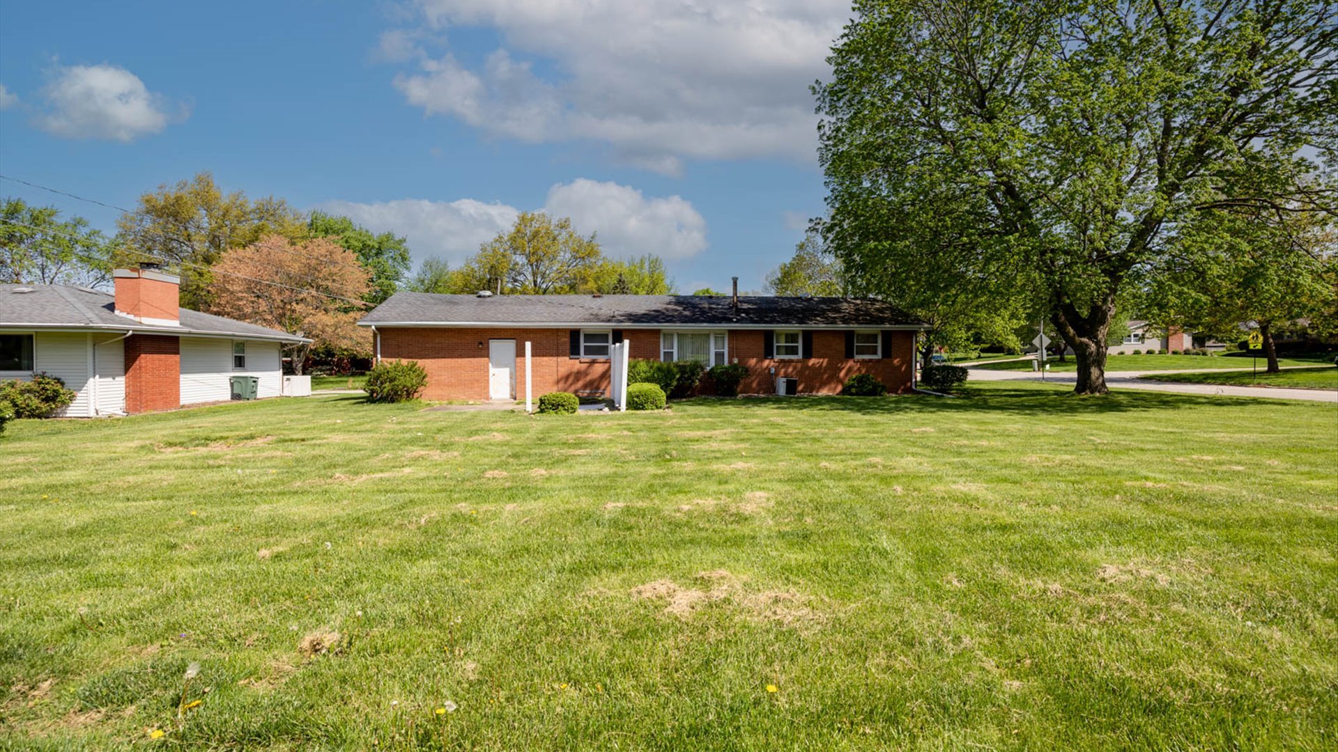 1209 Spear Drive Normal, IL 61761 - Photo 26 of 31 a view of a house next to a big yard and large trees