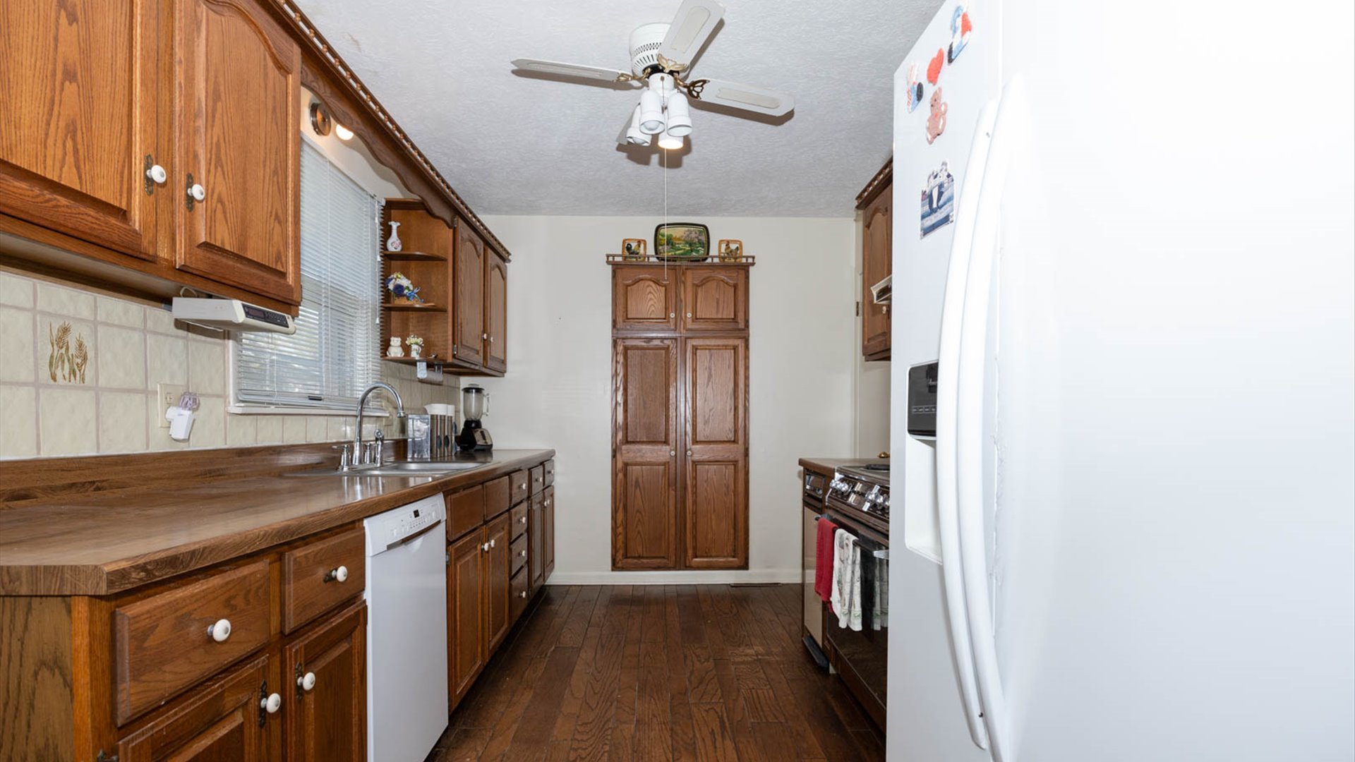 1209 Spear Drive Normal, IL 61761 - Photo 8 of 31 a kitchen with a sink refrigerator and cabinets