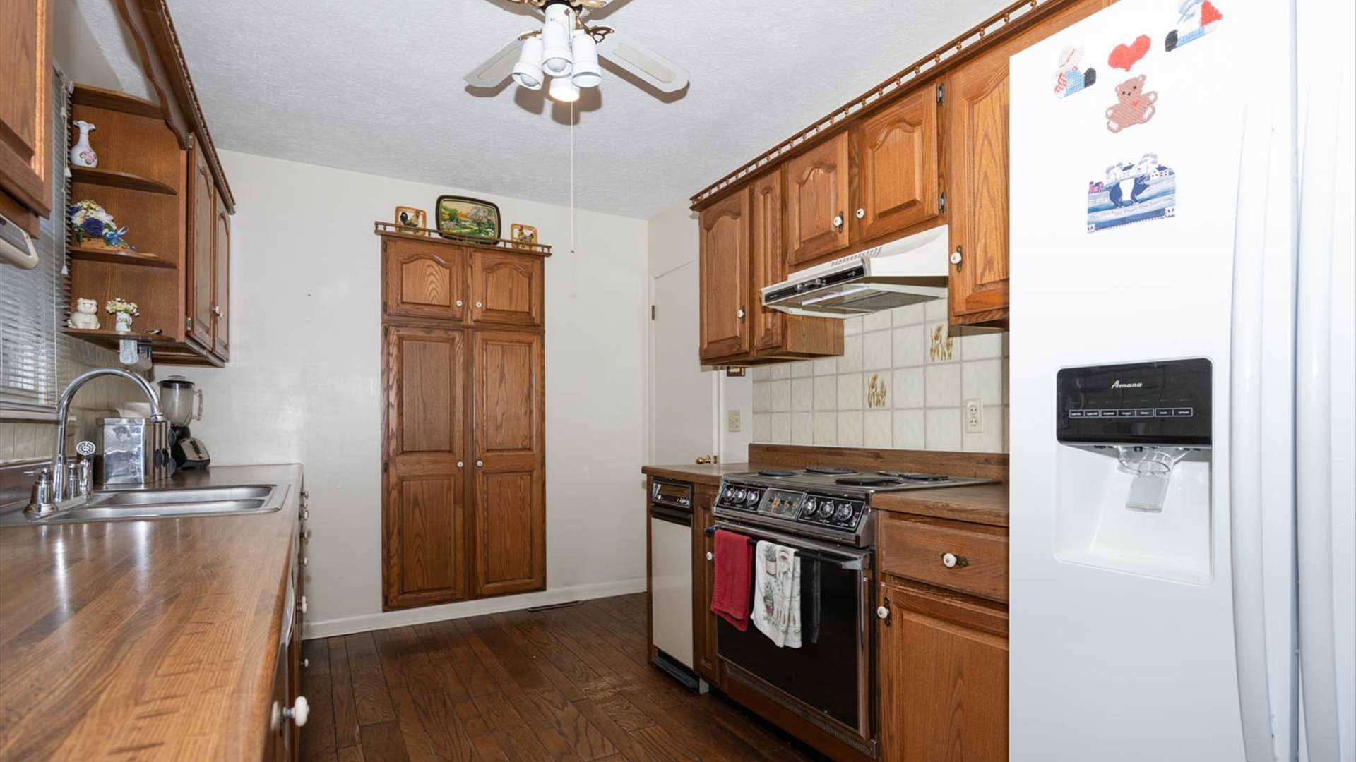 1209 Spear Drive Normal, IL 61761 - Photo 9 of 31 a kitchen with stainless steel appliances granite countertop a refrigerator a stove and a sink with wooden floor