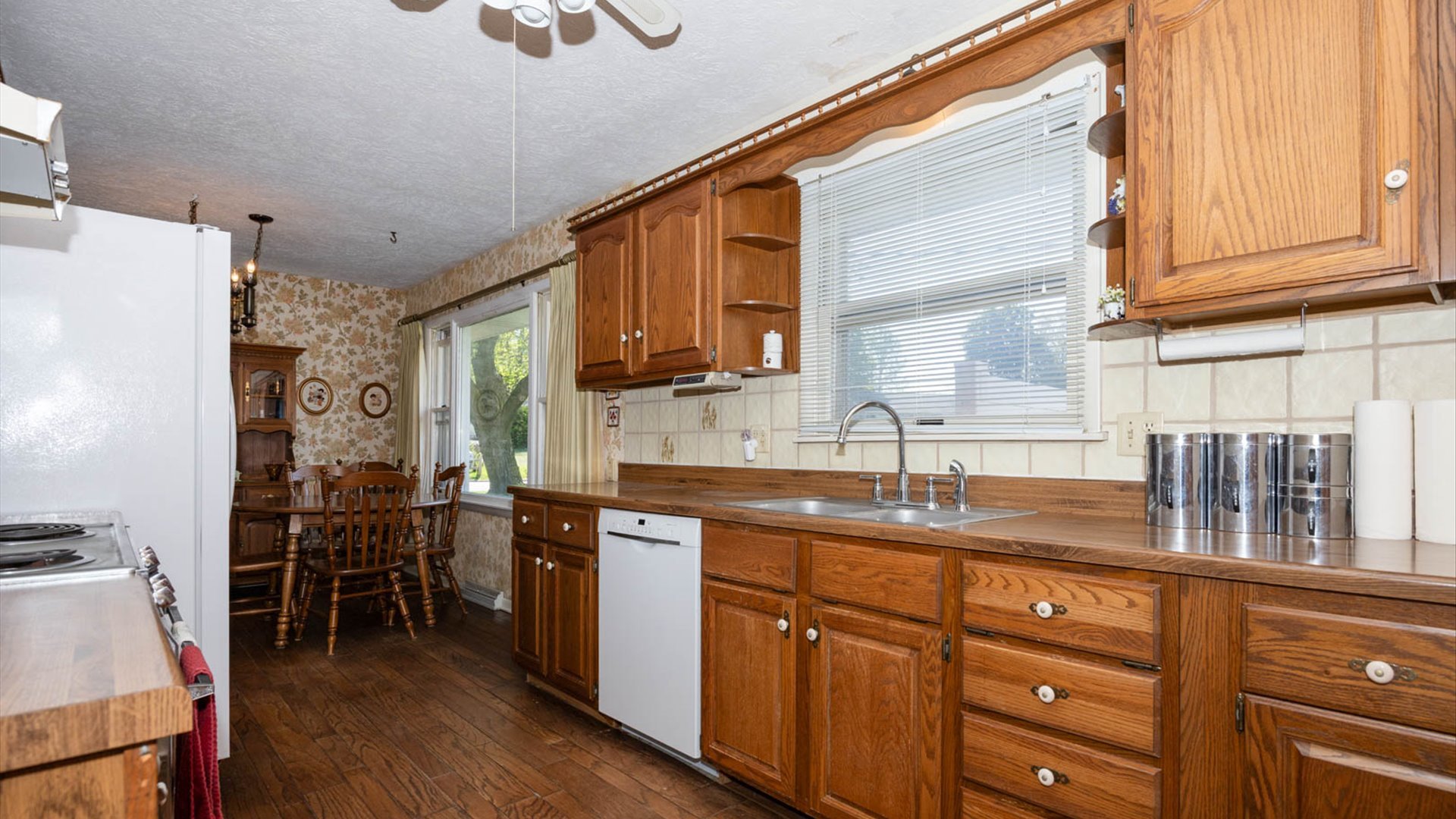 1209 Spear Drive Normal, IL 61761 - Photo 10 of 31 a kitchen with granite countertop a sink appliances cabinets and wooden floor