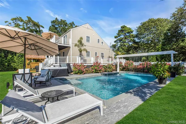 a view of a house with backyard and sitting area