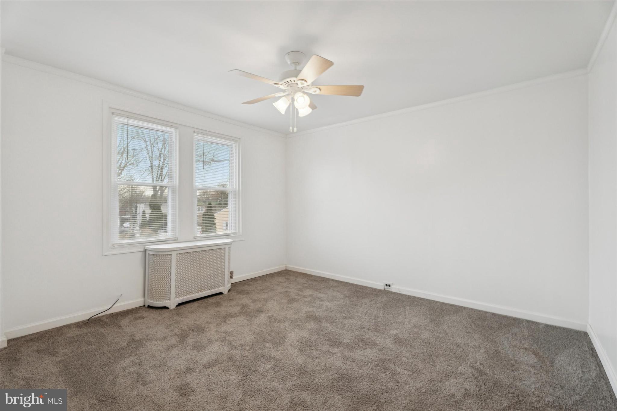 320 East Phil Ellena Street Philadelphia, PA 19119 - Photo 15 of 21 an empty room with chandelier fan and windows
