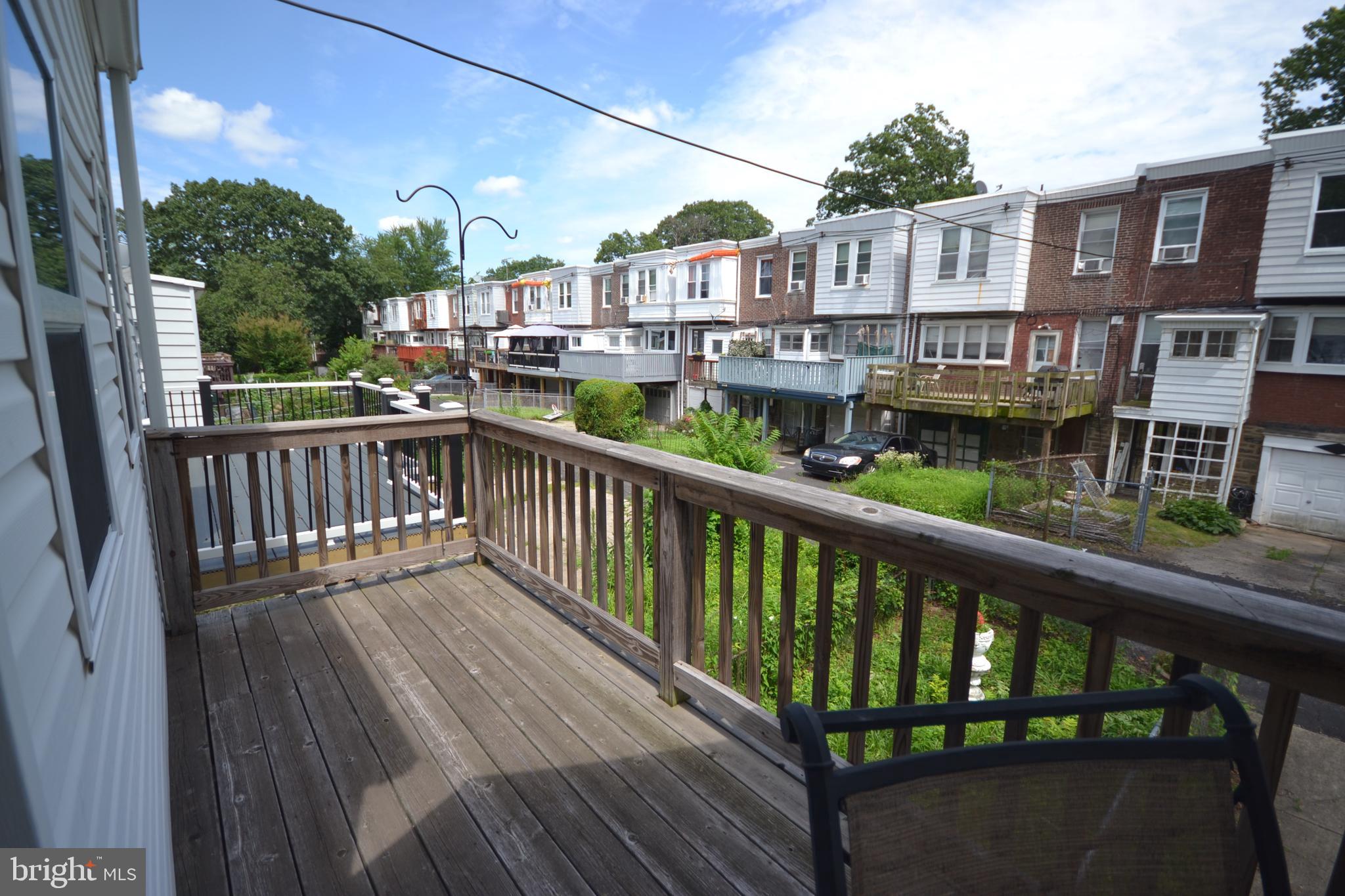 320 East Phil Ellena Street Philadelphia, PA 19119 - Photo 19 of 21 a view of a house with a deck and furniture