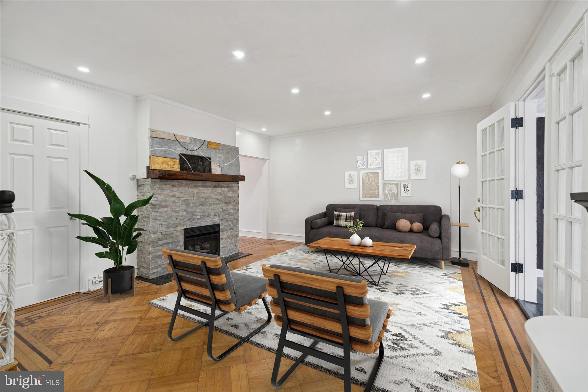 320 East Phil Ellena Street Philadelphia, PA 19119 - Photo 4 of 21 a living room with furniture a fireplace and a potted plant