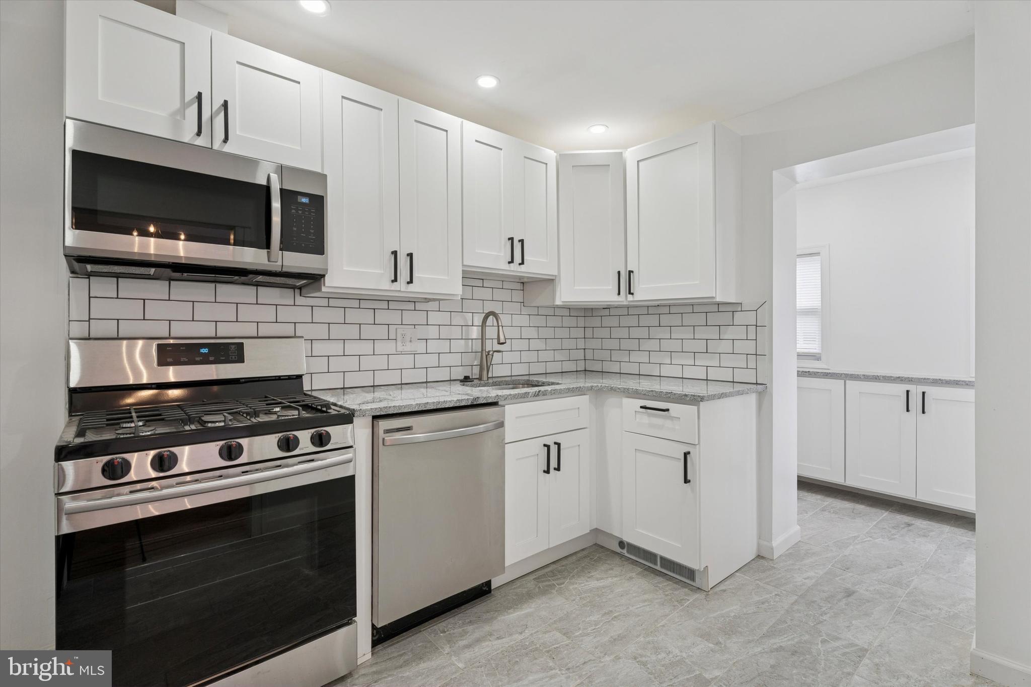 320 East Phil Ellena Street Philadelphia, PA 19119 - Photo 9 of 21 a kitchen with stainless steel appliances granite countertop a stove and a microwave