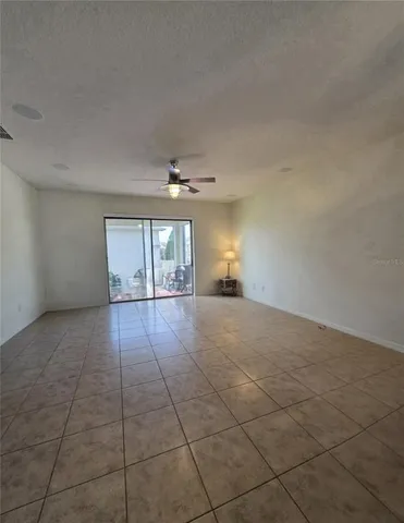 an empty room with a fireplace and windows
