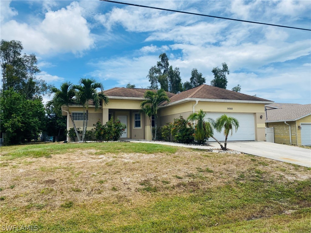 9060 Pineapple Road Fort Myers, FL 33967 - Photo 1 of 33 a front view of a house with a yard and potted plants