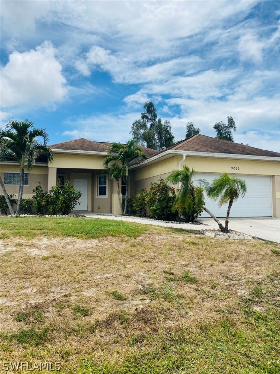 9060 Pineapple Road Fort Myers, FL 33967 - Photo 4 of 33 a view of a house with a yard and potted plants