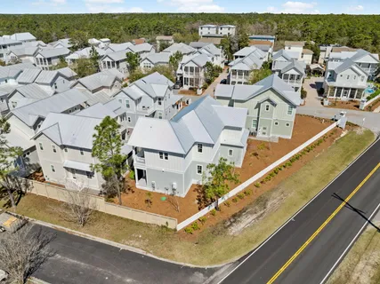 an aerial view of residential houses with outdoor space