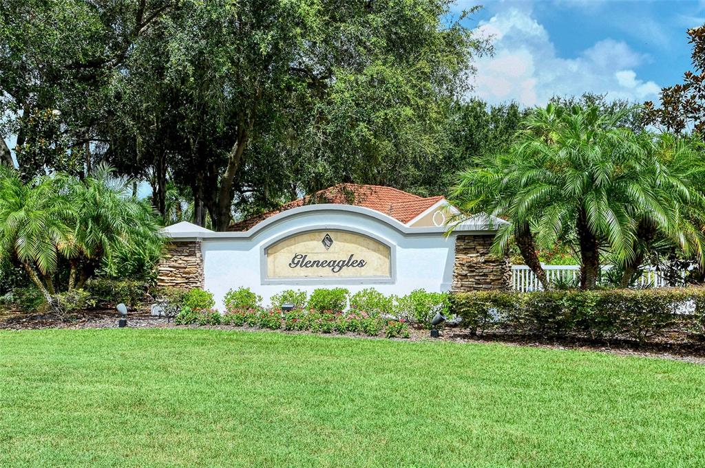 7717 US Open Loop Lakewood Ranch, FL 34202 - Photo 41 of 95 a sign that is sitting in front of a house with a big yard