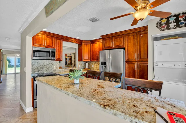 a kitchen with sink refrigerator and window