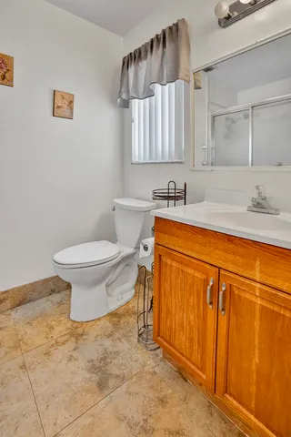 a bathroom with a sink a toilet and a mirror