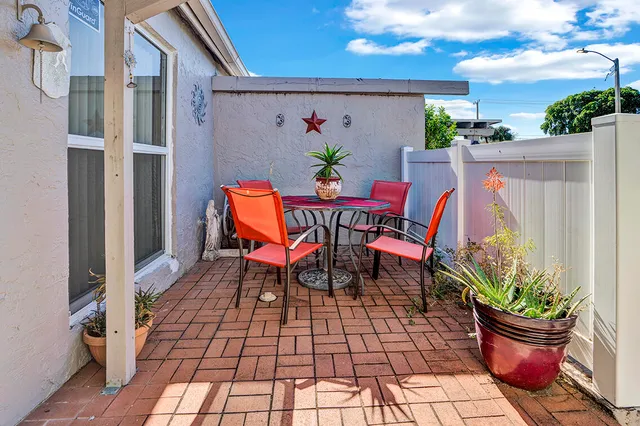 a outdoor space with a table and chairs
