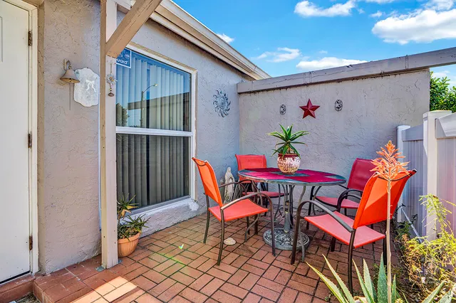 a balcony with table and chairs
