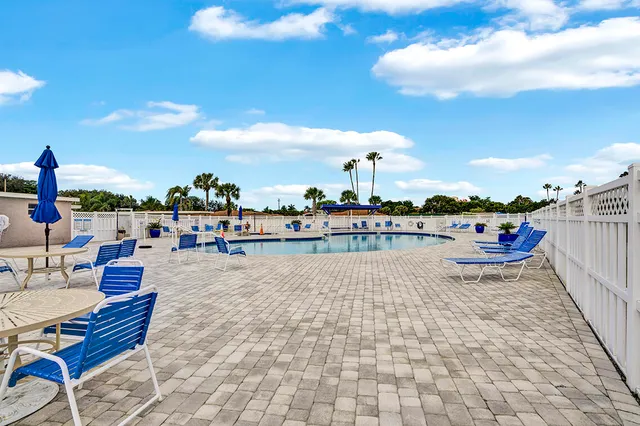 a view of a swimming pool with an outdoor seating
