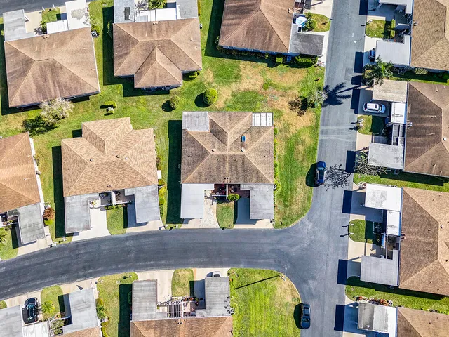 an aerial view of residential houses with outdoor space