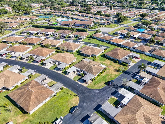 an aerial view of residential houses with outdoor space
