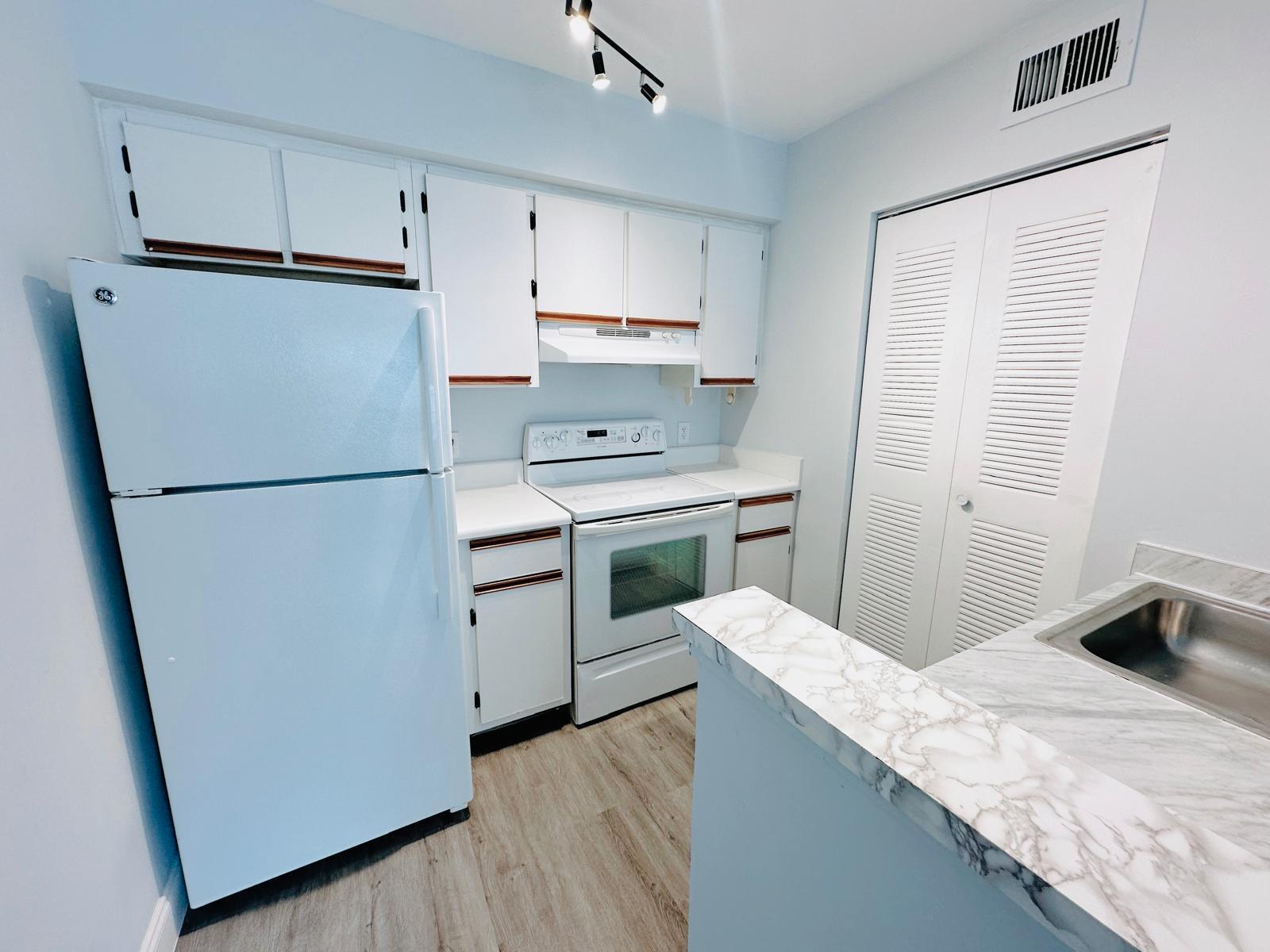 540 South Park Road Hollywood, FL 33021 - Photo 14 of 26 a kitchen with a sink a refrigerator and a stove