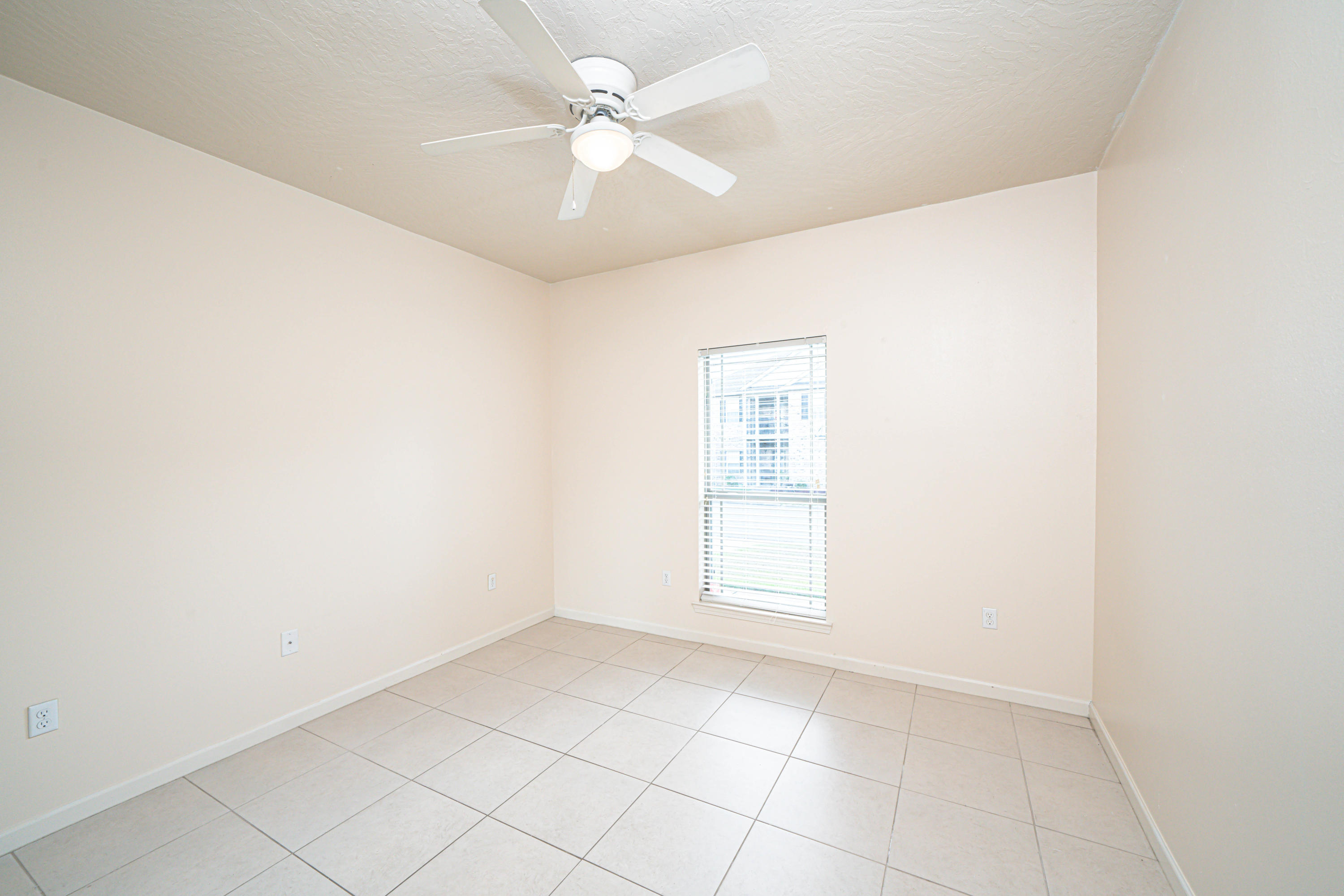 4582 Hermosa Road Crestview, FL 32539 - Photo 12 of 26 an empty room with windows and fan