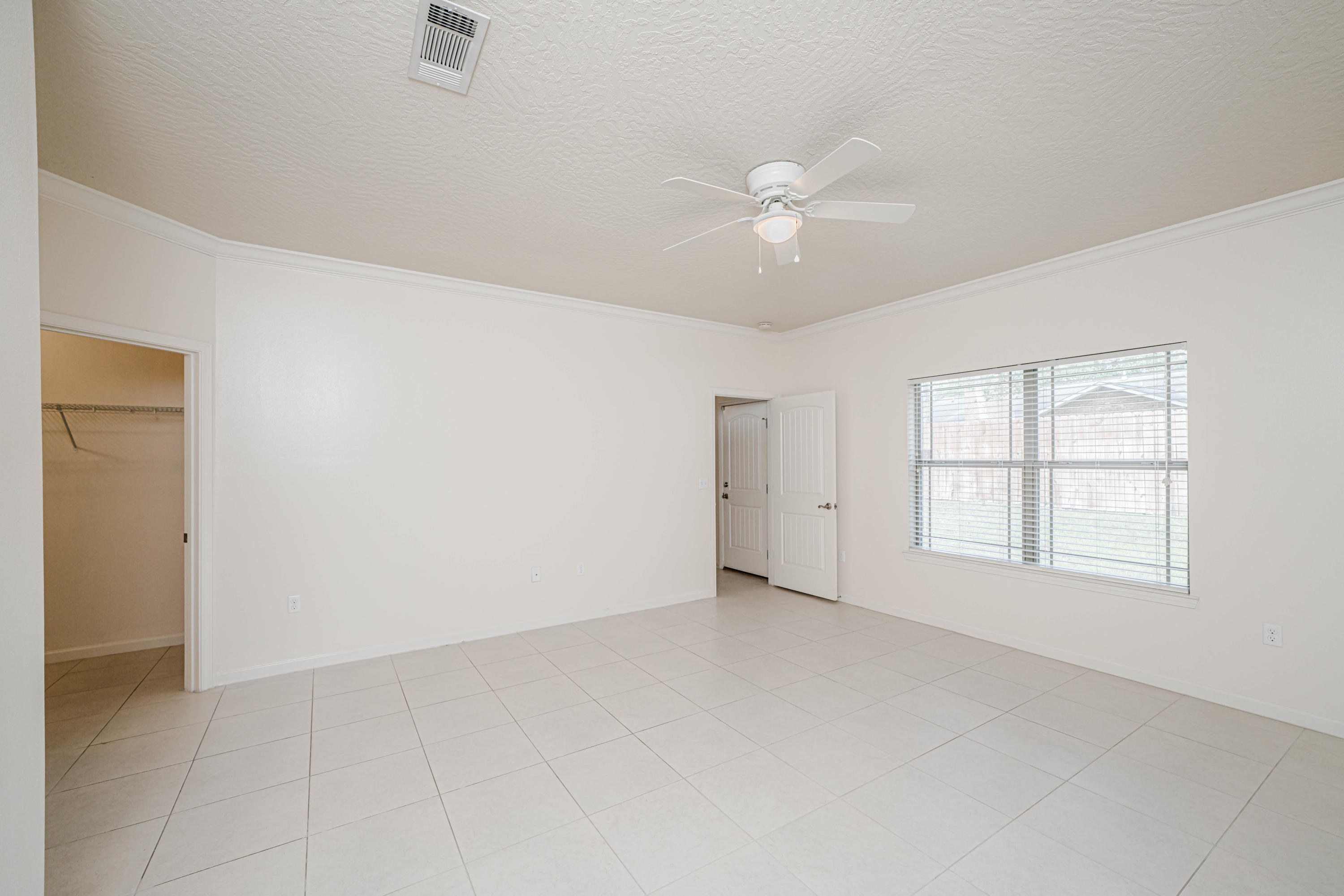 4582 Hermosa Road Crestview, FL 32539 - Photo 15 of 26 an empty room with chandelier fan and windows