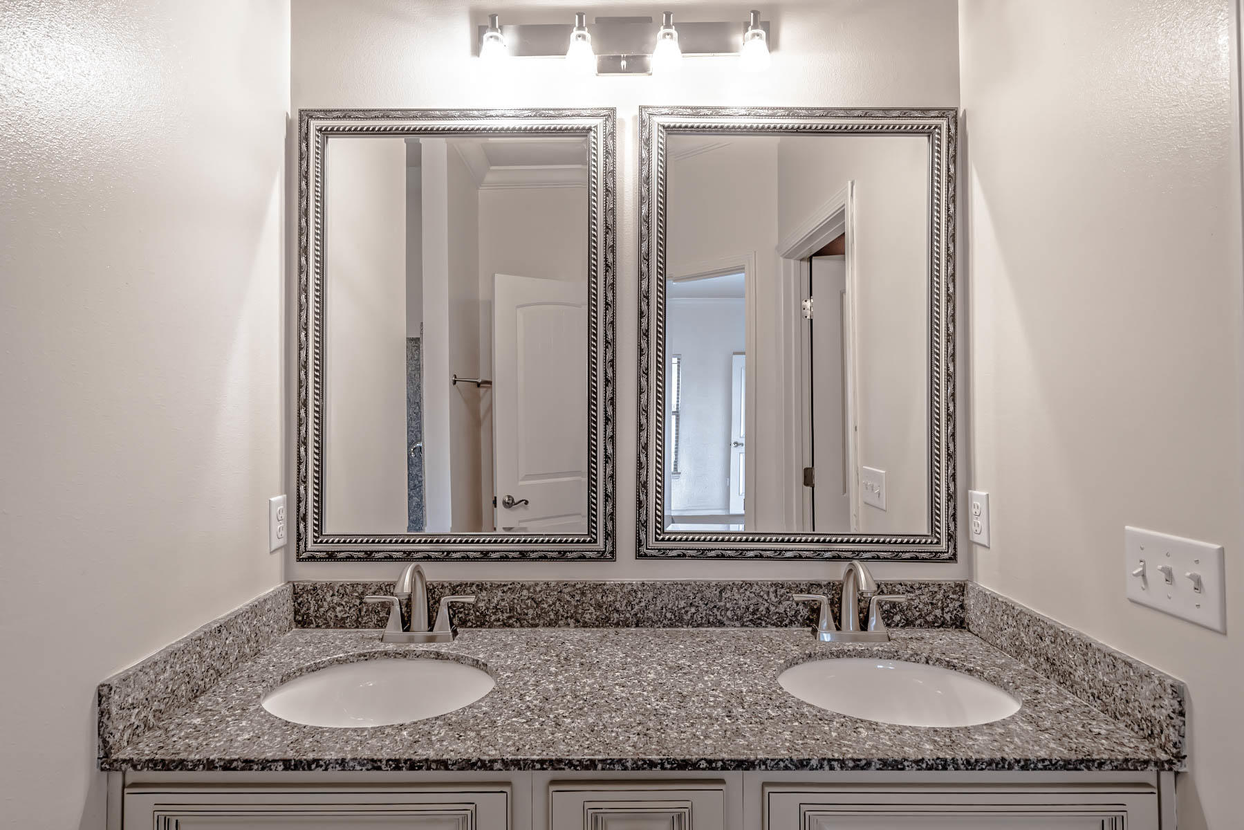 4582 Hermosa Road Crestview, FL 32539 - Photo 20 of 26 a bathroom with double granite countertop a sink and a mirror