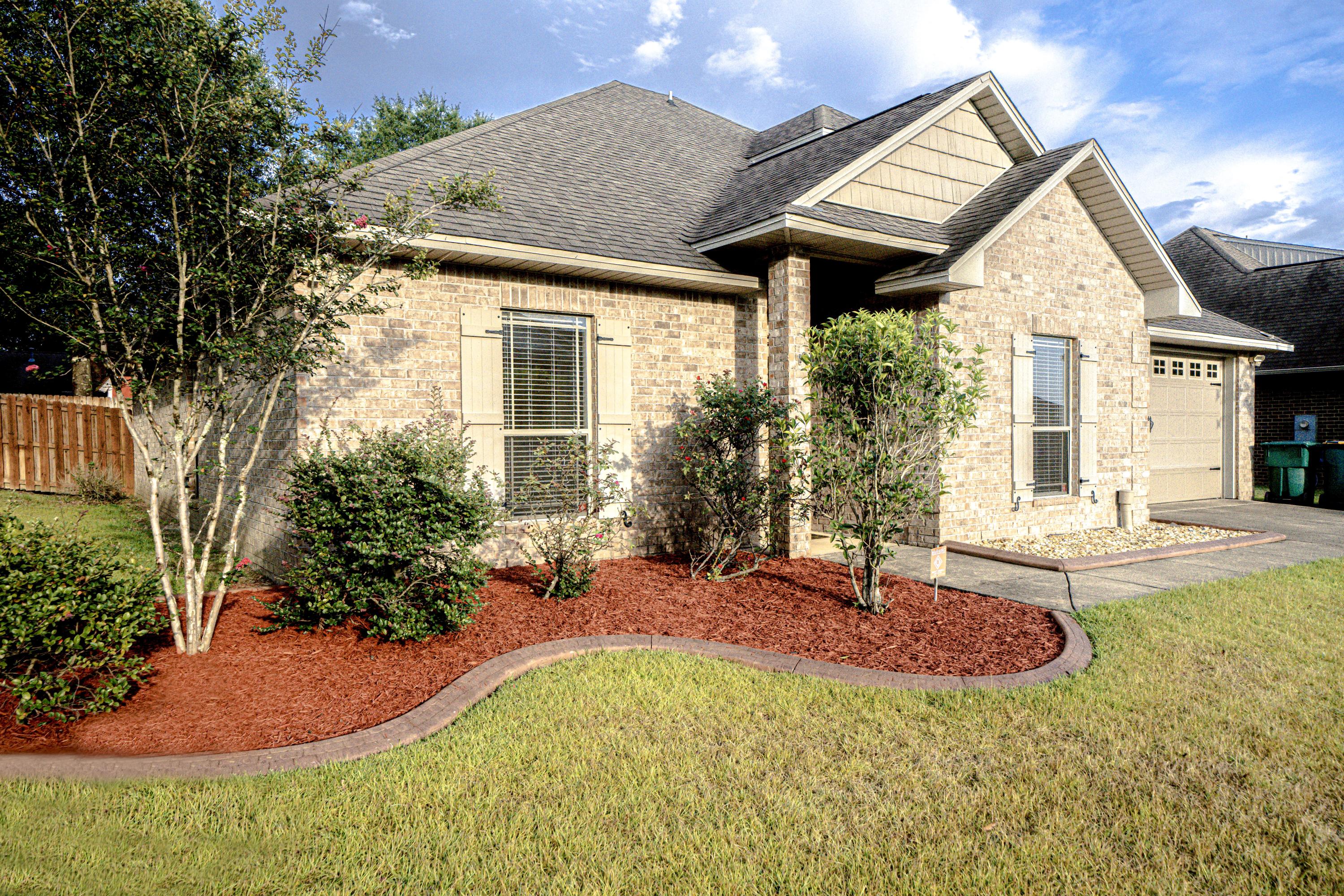4582 Hermosa Road Crestview, FL 32539 - Photo 2 of 26 a view of a house with backyard and sitting area