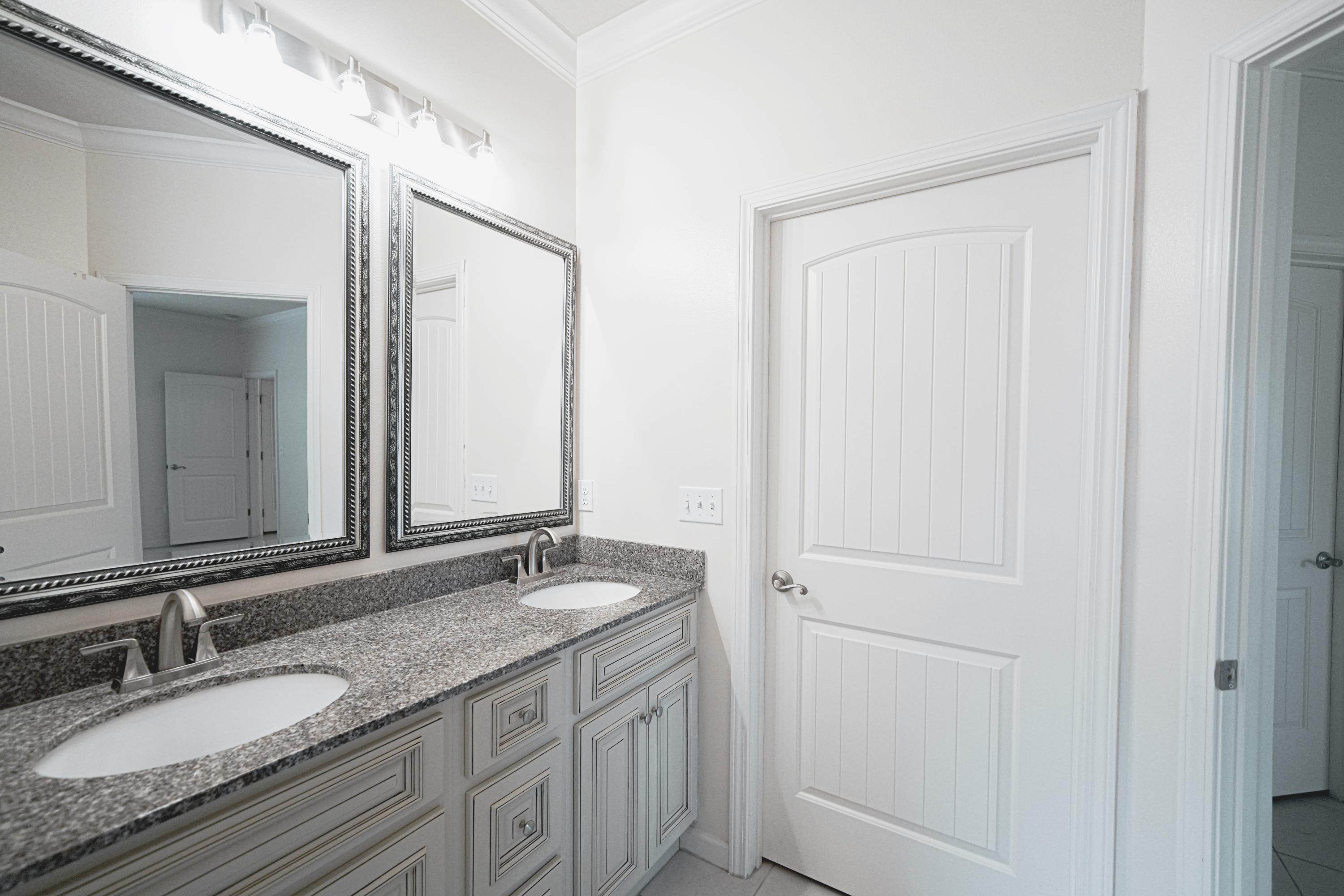 4582 Hermosa Road Crestview, FL 32539 - Photo 22 of 26 a bathroom with a granite countertop sink and a mirror